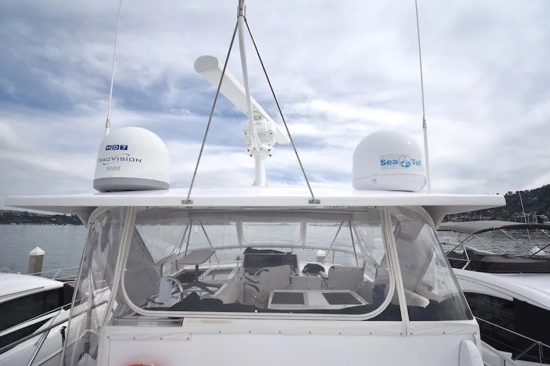 Slide: The Image of 2004 Ocean Alexander 58 Pilothouse yacht with radar and satellite domes, docked under cloudy skies. - 34
