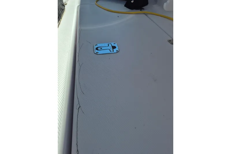 Slide: The Image of Deck of 2000 Pro-Line 24 Sport boat with metal latch and yellow cable. - 45