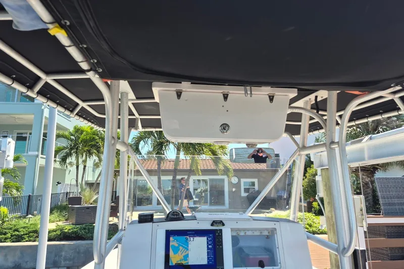 Slide: The Image of Interior view of a 2000 Pro-Line 24 Sport boat with navigation equipment and canopy. - 25