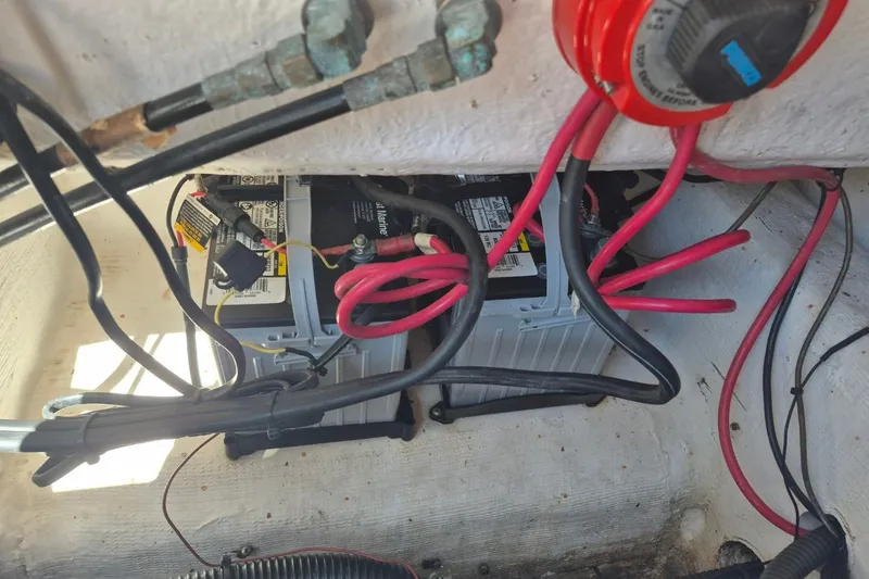 Slide: The Image of Battery compartment of a 2000 Pro-Line 24 Sport boat with wiring and connections. - 32