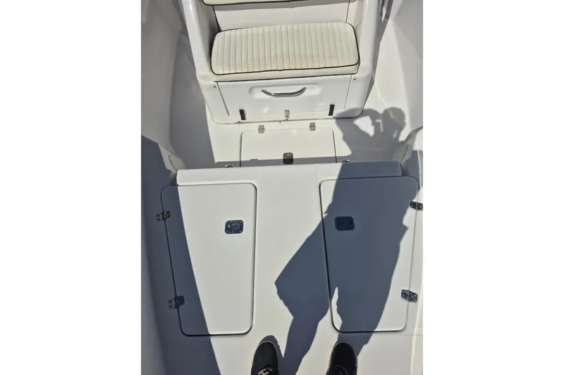 Slide: The Image of 2000 Pro-Line 24 Sport boat interior with storage compartments and seating. - 29
