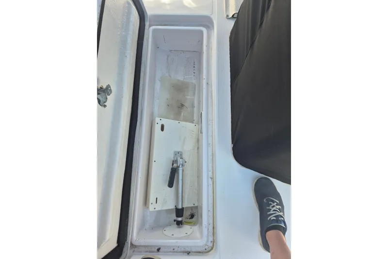 Slide: The Image of Open storage compartment on a 2000 Pro-Line 24 Sport boat, showing interior details. - 18