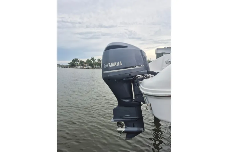 Slide: The Image of Yamaha outboard motor on a 2000 Pro-Line 24 Sport boat, docked on a calm waterway. - 30