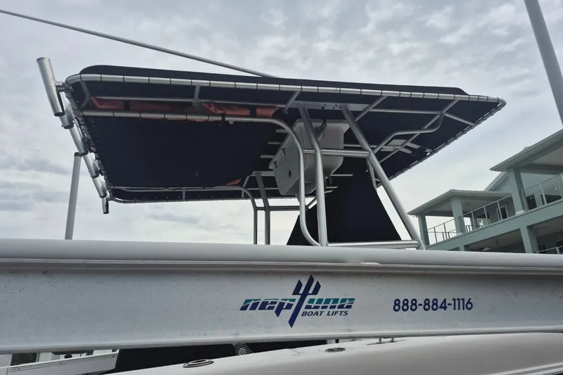 Slide: The Image of Pro-Line 24 Sport 2000 boat on Neptune Boat Lift, cloudy sky background. - 23