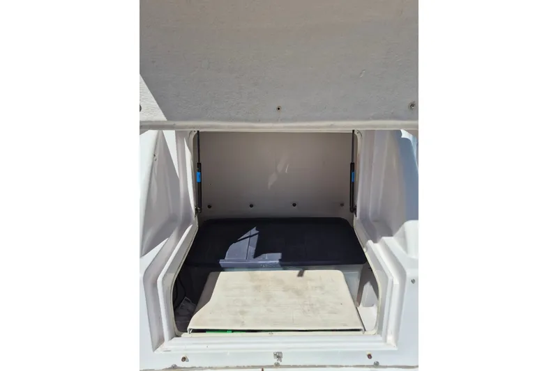 Slide: The Image of Storage compartment of a 2000 Pro-Line 24 Sport boat, open and empty. - 34