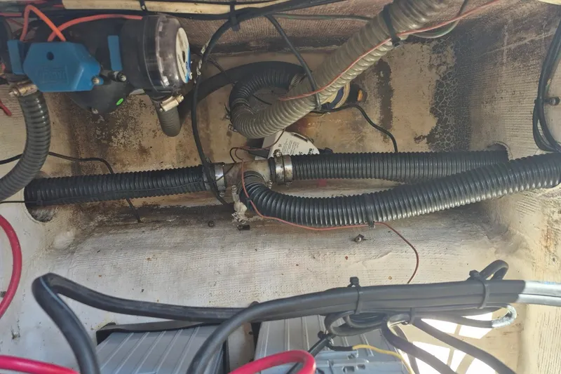 Slide: The Image of Electrical and plumbing components inside a 2000 Pro-Line 24 Sport boat. - 36