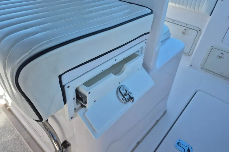 Slide: The Image of Interior of a 2000 Pro-Line 24 Sport boat, featuring white seating and storage compartments. - 15