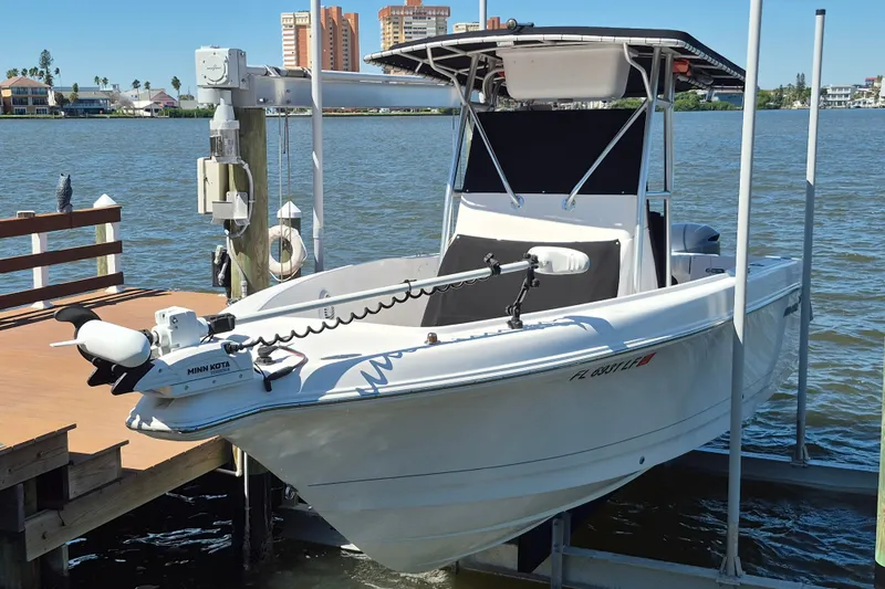 The Image of 2000 Pro-Line 24 Sport boat docked by waterfront with Minn Kota motor. - 0