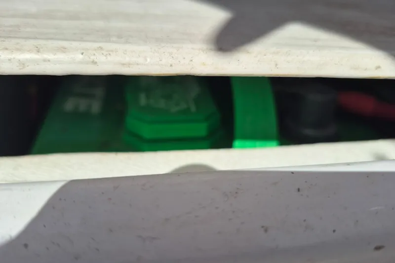 Slide: The Image of Close-up of a green battery inside a 2000 Pro-Line 24 Sport boat. - 37