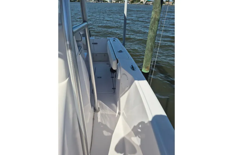 Slide: The Image of 2000 Pro-Line 24 Sport boat docked on calm water, showcasing sleek design and spacious deck. - 39