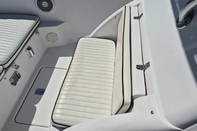 Slide: The Image of White cushioned seating on a 2000 Pro-Line 24 Sport boat interior. - 19