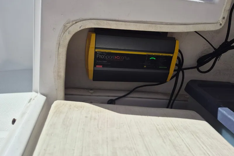Slide: The Image of Onboard battery charger in a 2000 Pro-Line 24 Sport boat compartment. - 35