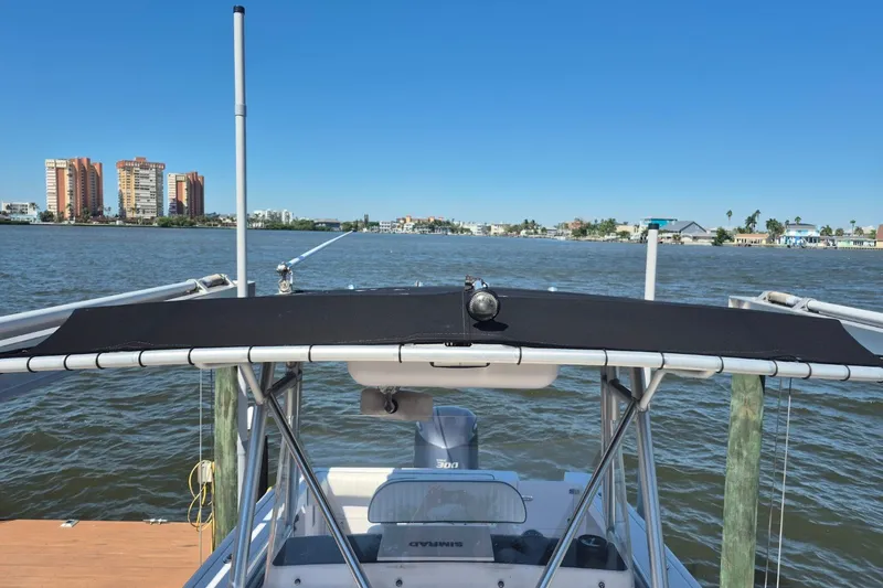 Slide: The Image of 2000 Pro-Line 24 Sport boat on water with cityscape in background. - 28