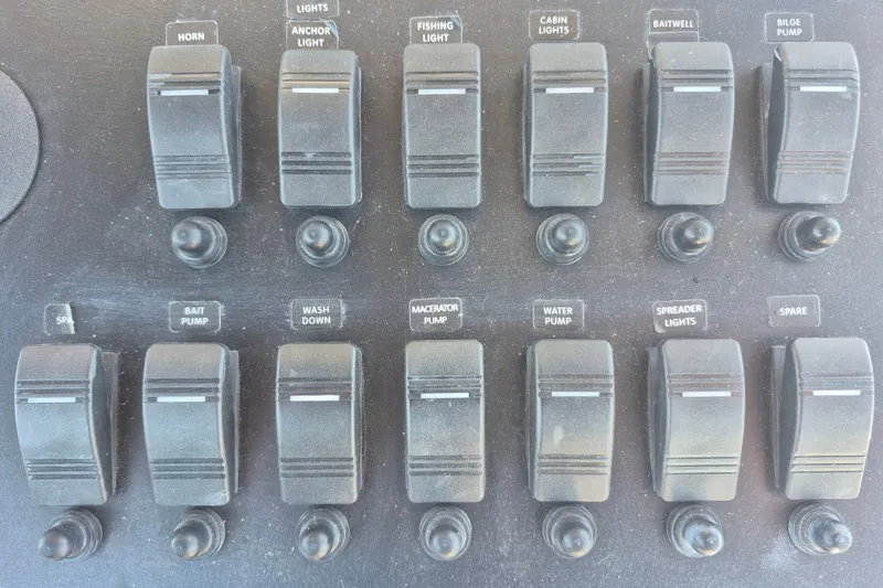 Slide: The Image of Control panel of a 2000 Pro-Line 24 Sport boat with labeled switches and buttons. - 14