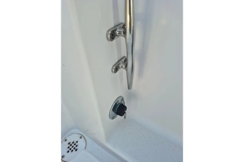 Slide: The Image of Close-up of a 2000 Pro-Line 24 Sport boat's deck hardware and drain plug. - 22