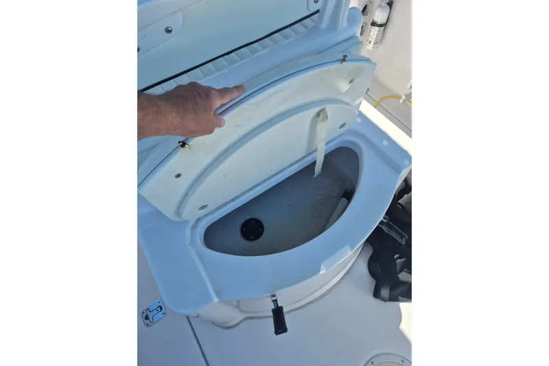 Slide: The Image of Open storage compartment on a 2000 Pro-Line 24 Sport boat. - 16