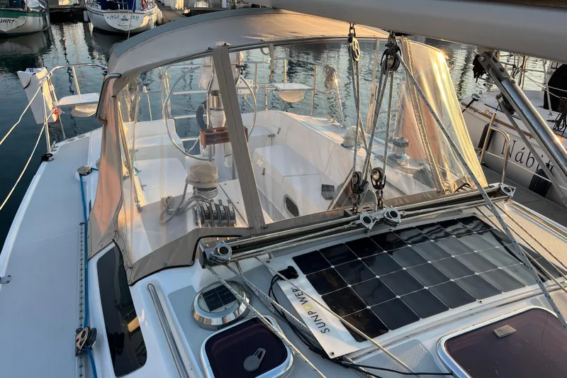 Slide: The Image of 2005 Catalina 320 sailboat with solar panels docked at marina. - 22