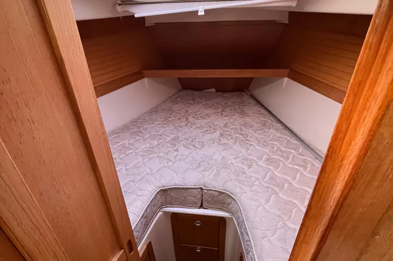 Slide: The Image of Cozy cabin interior of a 2005 Catalina 320 sailboat with a comfortable bed. - 9