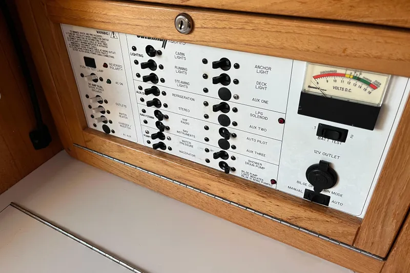 Slide: The Image of Control panel of a 2005 Catalina 320 sailboat with various switches and a voltmeter. - 15