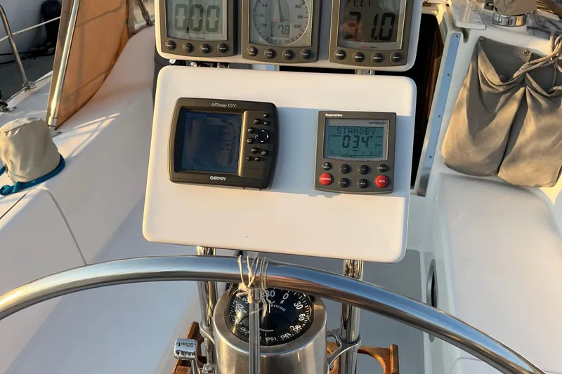 Slide: The Image of Cockpit of 2005 Catalina 320 sailboat with navigation instruments and steering wheel. - 31