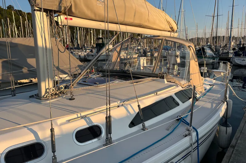 Slide: The Image of 2005 Catalina 320 sailboat docked at marina during sunset, showcasing sleek design and rigging. - 20