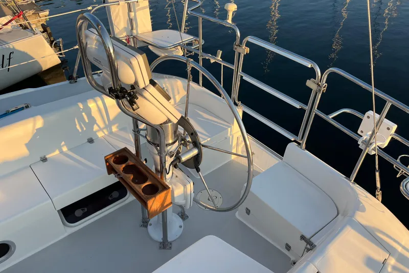 Slide: The Image of Cockpit of a 2005 Catalina 320 sailboat with steering wheel and seating. - 29