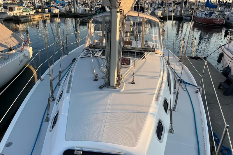 Slide: The Image of Catalina 320 sailboat from 2005 docked at a marina, surrounded by other boats. - 19