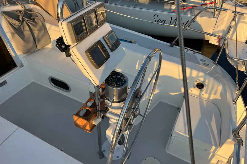 Slide: The Image of Cockpit of 2005 Catalina 320 sailboat with steering wheel and navigation instruments. - 28