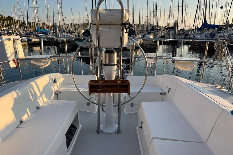 Slide: The Image of Cockpit of 2005 Catalina 320 sailboat docked at marina during sunset. - 30