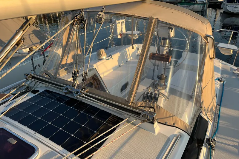 Slide: The Image of 2005 Catalina 320 sailboat cockpit with solar panel and protective canopy. - 23
