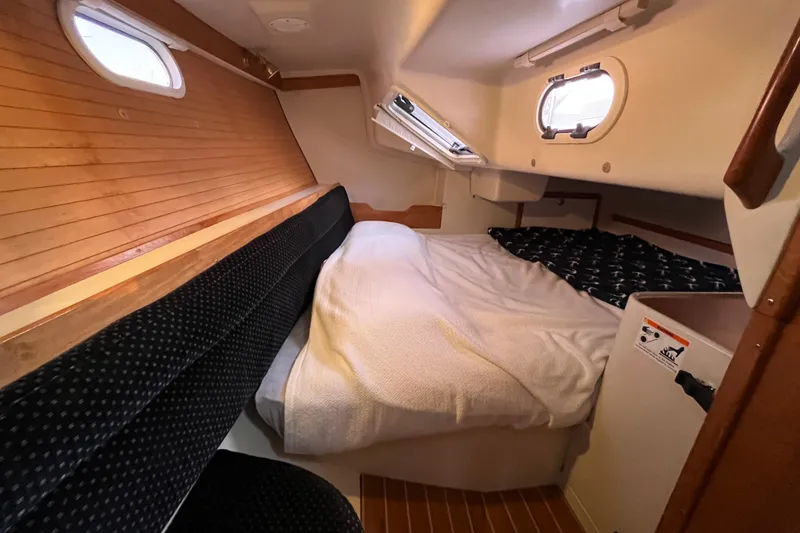 Slide: The Image of Cozy cabin interior of 2005 Catalina 320 sailboat with bed and wooden accents. - 7