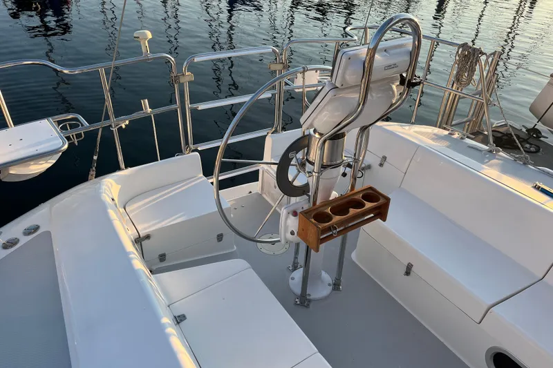 Slide: The Image of Cockpit of 2005 Catalina 320 sailboat with steering wheel and seating. - 27