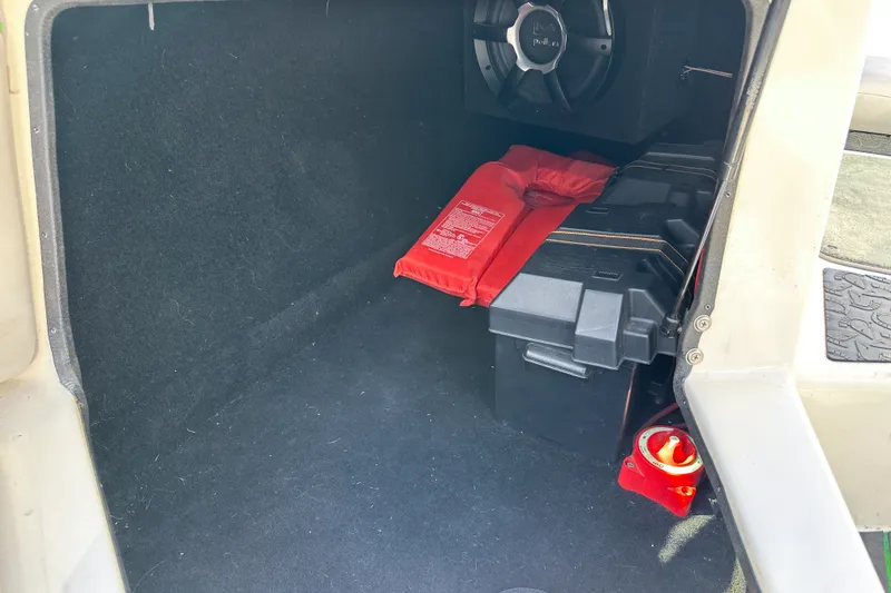 Slide: The Image of Storage compartment of 2008 Centurion Air Warrior Elite Bowrider with life jacket and battery box. - 13