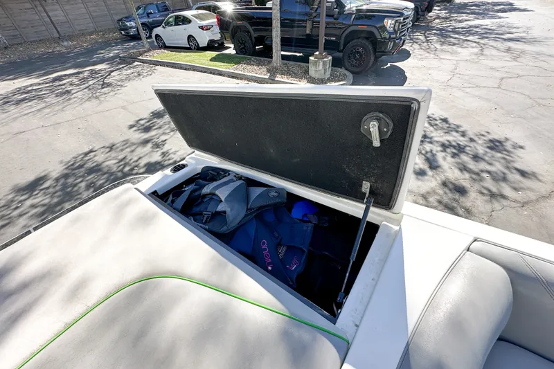 Slide: The Image of Open storage compartment in 2008 Centurion Air Warrior Elite Bowrider boat, containing life jackets. - 18