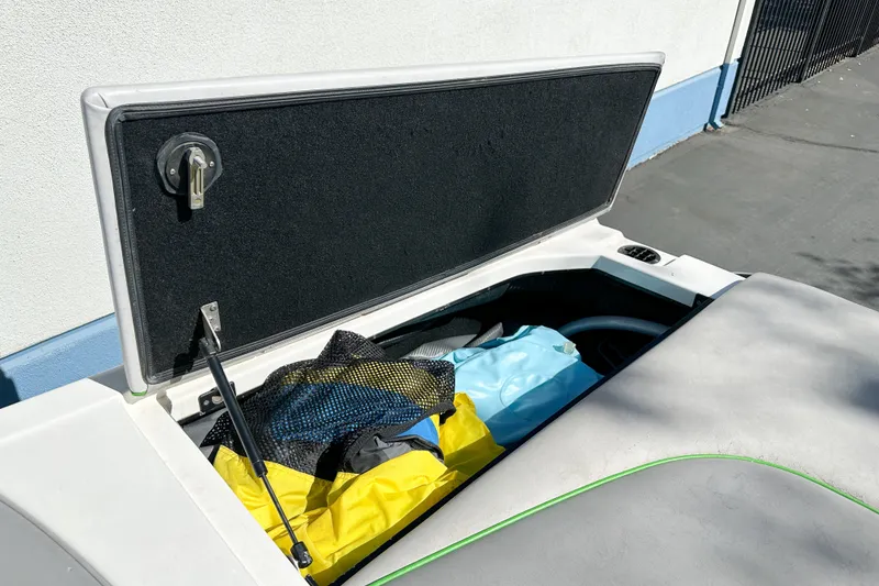 Slide: The Image of Open storage compartment on 2008 Centurion Air Warrior Elite Bowrider with colorful gear inside. - 19