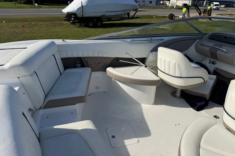 Slide: The Image of Interior of a 2004 Cobalt 250 boat with white seating and dashboard. - 14