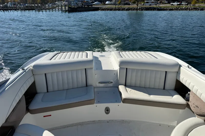 Slide: The Image of 2004 Cobalt 250 boat interior with white seating, cruising on a sunny day. - 17