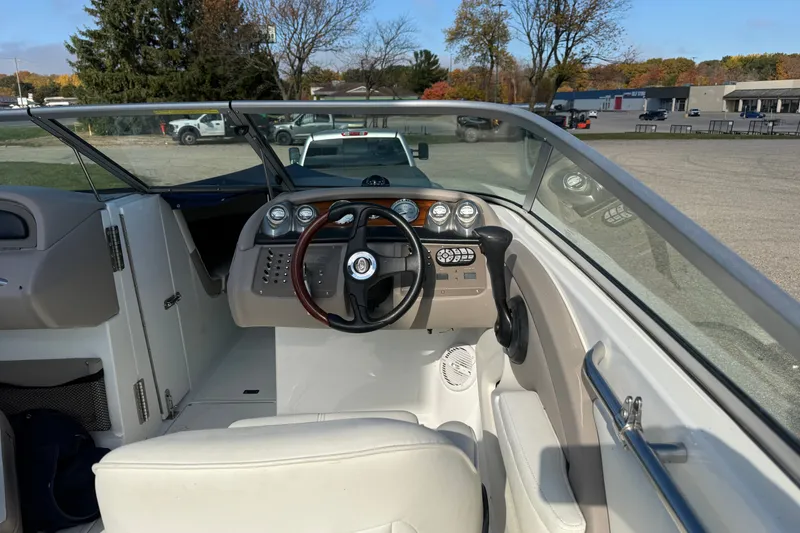 Slide: The Image of Interior view of a 2004 Cobalt 250 boat cockpit with steering wheel and controls. - 13