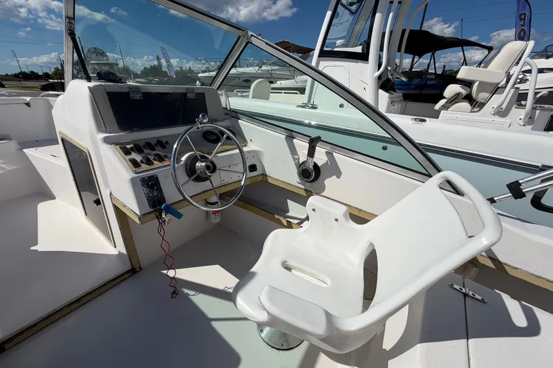 Slide: The Image of 1994 Grady-White Tournament 197 boat cockpit with steering wheel and seating. - 12