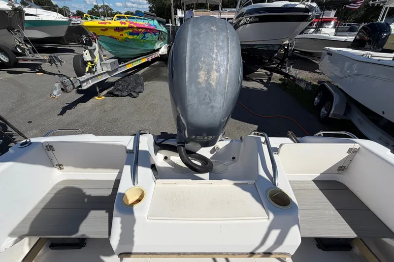 Slide: The Image of 1994 Grady-White Tournament 197 boat with outboard motor, parked among other boats. - 18