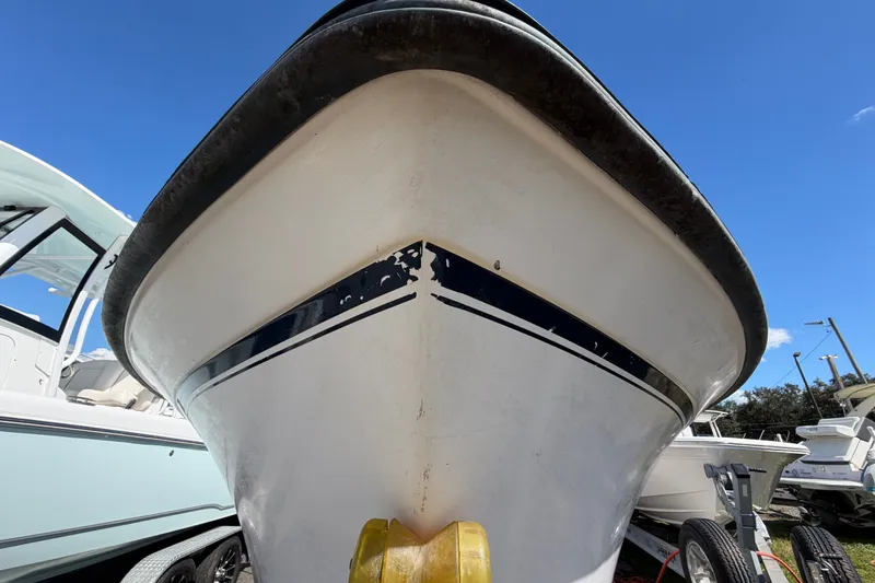 Slide: The Image of 1994 Grady-White Tournament 197 boat, close-up view, showcasing hull and trailer. - 7