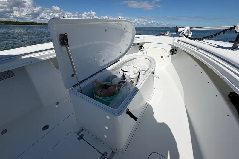 Slide: The Image of Open storage compartment on 2010 Yellowfin 32 Offshore boat, with fishing gear and scenic ocean view. - 19