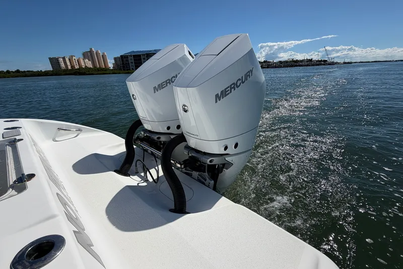 Slide: The Image of 2010 Yellowfin 32 Offshore boat with twin Mercury engines on water. - 28
