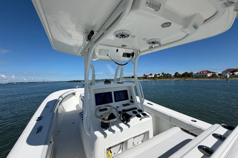 Slide: The Image of 2010 Yellowfin 32 Offshore boat interior with navigation system, cruising on calm waters. - 34