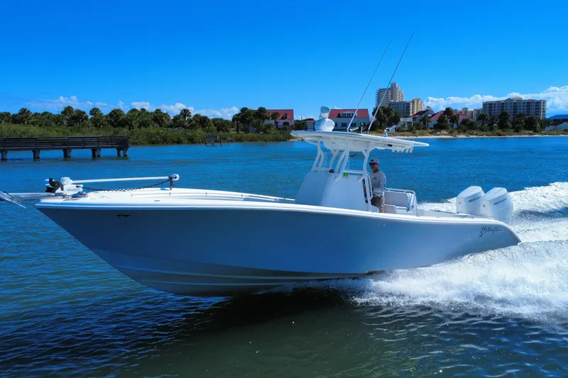 The Image of 2010 Yellowfin 32 Offshore boat cruising on a sunny day near a coastal city. - 0