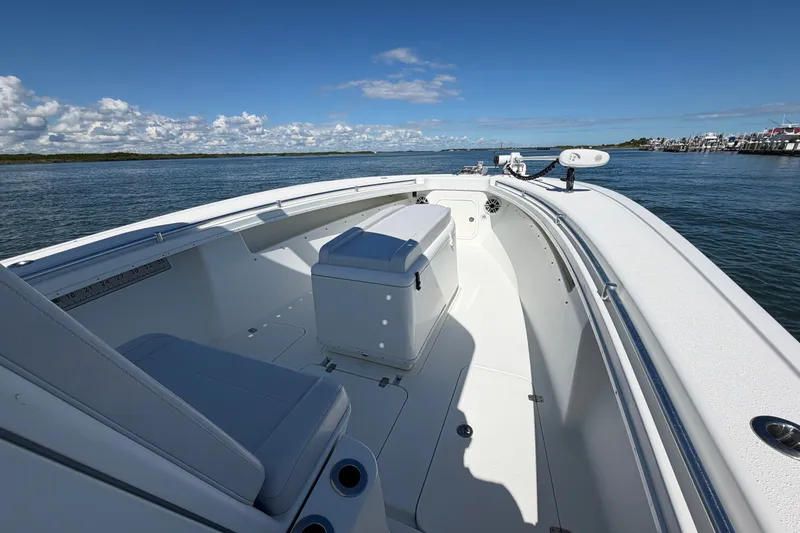 Slide: The Image of 2010 Yellowfin 32 Offshore boat on calm waters under a clear blue sky. - 13
