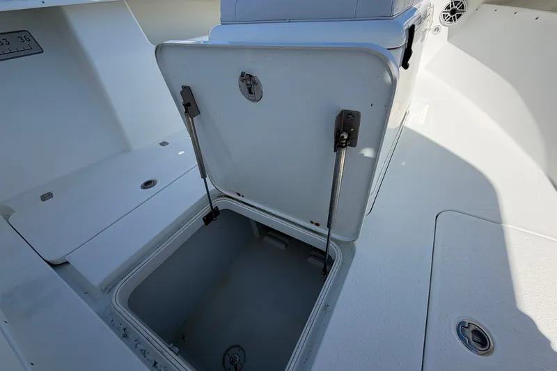Slide: The Image of Open storage compartment on a 2010 Yellowfin 32 Offshore boat deck. - 24