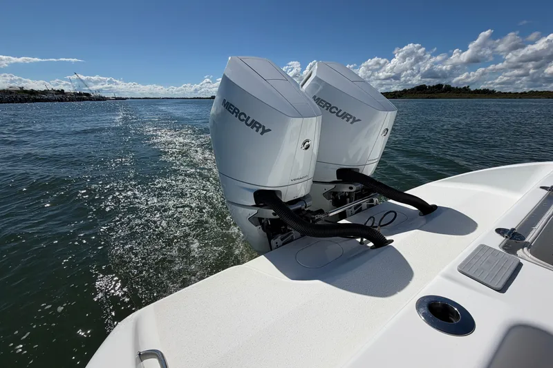 Slide: The Image of 2010 Yellowfin 32 Offshore boat with twin Mercury outboard engines on open water. - 26