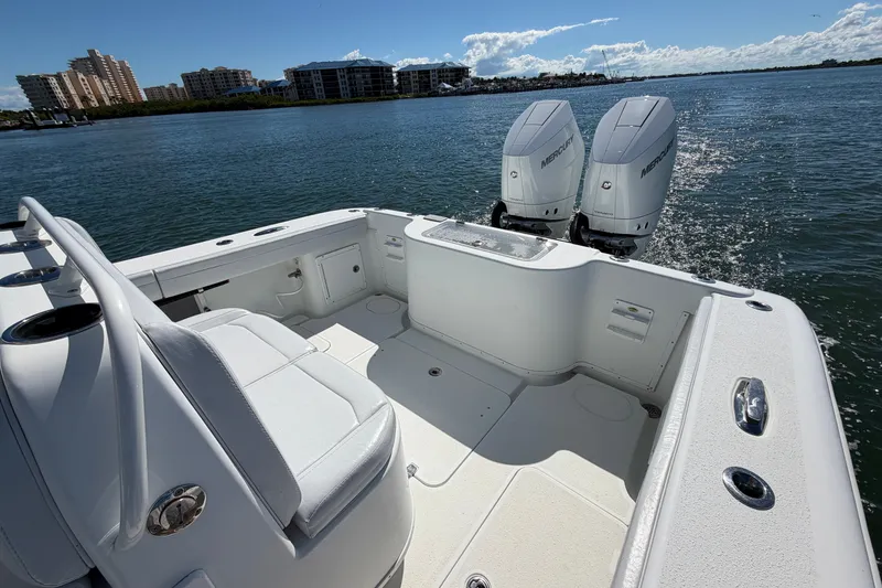 Slide: The Image of 2010 Yellowfin 32 Offshore boat with dual Mercury engines on calm water. - 32