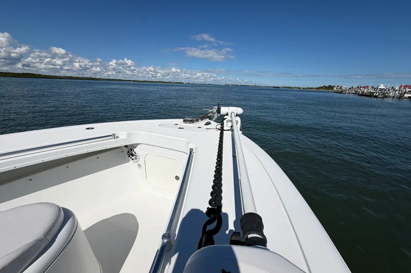 Slide: The Image of 2010 Yellowfin 32 Offshore boat cruising on calm waters under a clear blue sky. - 17